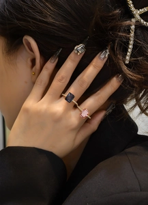 Detail of s925 silver double-stone ring with blue and pink ice-cut rectangular gems