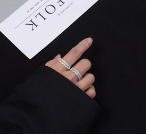Detail of wavy gold and silver stackable rings with sparkling rectangular crystals