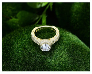 Macro shot of 925 hallmark on a luxury gold-plated ring with a 7mm round gemstone