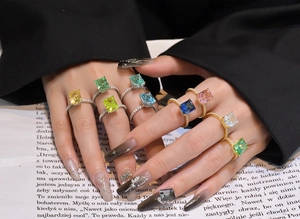 Detail showing colorful emerald-cut crystals with micro-pave cubic zirconia on bands
