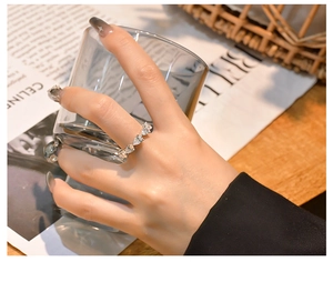 Detail view of a 925 silver ring featuring pear-cut stones in a claw setting on a hand