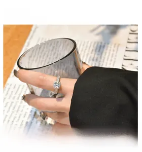 On-hand display of a S925 sterling silver ring with 7mm cushion cut carbon diamond