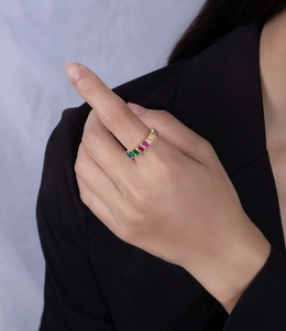 Close-up of rainbow gemstone ring in 14k gold plating worn with a black blazer