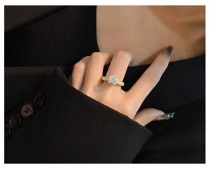 Detail of s925 silver ring with 7mm cushion cut stone on a hand with black blazer