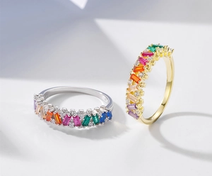 Macro shot of S925 silver and gold rings featuring rainbow baguette-cut gemstones