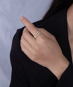 Macro shot of a gold-plated S925 silver ring featuring rainbow gradient gemstones and pave diamonds
