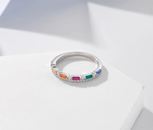 Macro shot of S925 silver ring featuring colorful baguette gems and pavé zircon details
