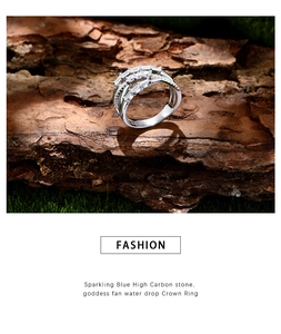Detail of 925 sterling silver multilayer ring with stones on mossy bark base