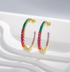 Detail view of large C-shaped hoop earrings with rainbow colorful zircon inlay in S925 silver