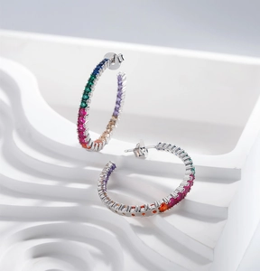 Macro view of S925 sterling silver hoop earrings with multicolored zircon pavé stones