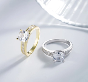 Close-up of square-cut high carbon diamond rings in silver and gold-plated finishes