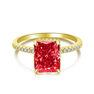 Elegant gold plated ring with large emerald-cut red gemstone and diamond accents