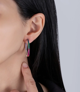 Close-up of rainbow cubic zirconia hoop earrings featuring multi-color micro-pave stones