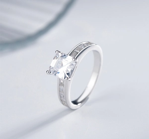 Macro shot of silver princess cut diamond engagement ring with adjustable band detail