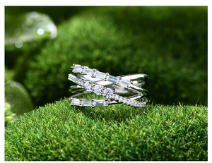 Macro view of multi-layer 925 silver bamboo ring with baguette-cut zircons on moss