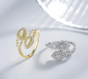 Detail of adjustable open rings with pear-shaped cubic zirconia in gold and silver