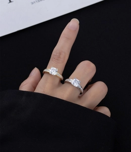 Macro shot of silver and gold square cut rings with channel set side stones on finger