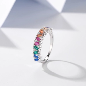 S925 sterling silver rainbow ring with colorful baguette-cut stones on geometric background
