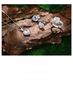 Macro di set gioielli a cuore con cristalli scintillanti su muschio naturale e corteccia
