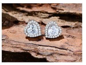 Macro di orecchini a cuore in argento 925 con diamanti halo su corteccia di legno