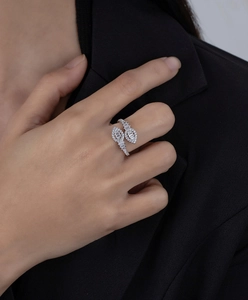 Macro shot of silver wrap ring with sparkling crystals on black blazer background