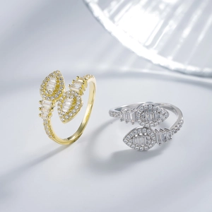 Elegant gold and silver wrap rings featuring pear and emerald cut cubic zirconia crystals