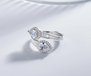 Macro detail of teardrop high carbon diamond ring with pavé stones and bypass band