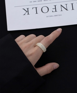 Close-up of wide 14k gold plated sterling silver ring with micro-paved square zircons