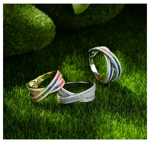 Close-up of S925 sterling silver stamp on crisscross eternity rings with colorful stones