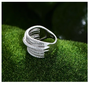 Detailed macro view of 925 sterling silver multi-layer crossover ring with inlaid zircons