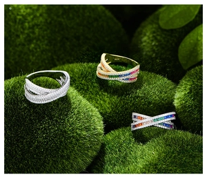 Detailed macro view of S925 silver rings with colorful zircon on natural green moss