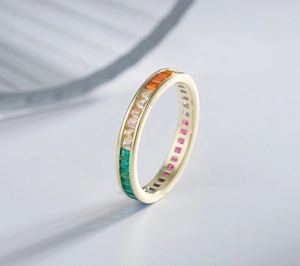 Macro shot of gold-plated 925 silver ring featuring rainbow baguette-cut zirconias