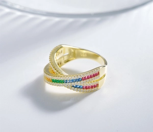 Detail of 925 silver cross ring with rainbow cubic zirconia and gold finish