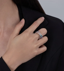 Macro shot of 925 sterling silver ring featuring crisscross bands with multi-color zircons