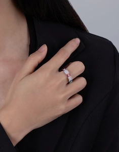 Detail of colorful gemstone eternity ring with baguette-cut accents on hand