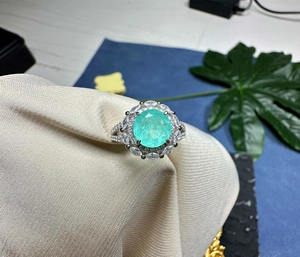 Detailed macro view of 8mm Paraiba gemstone ring with marquise cut side stones