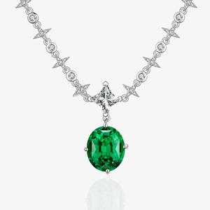 Detailed macro of a 925 silver necklace with 10x12mm green emerald pendant and star accents