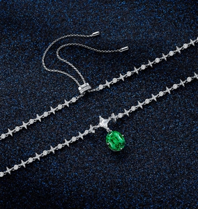 Detailed view of silver necklace with emerald pendant and adjustable sliding clasp