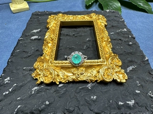 Detail of 8mm mint green Paraiba ring with halo stones in a vintage silver setting
