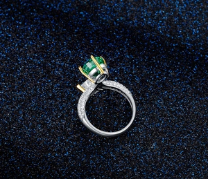 Macro shot of 925 silver ring with emerald cut green gem and sparkling pavé setting