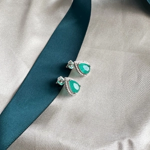Pear cut emerald green stud earrings in 925 sterling silver with halo cubic zirconia