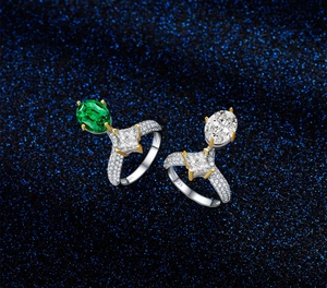 Detailed macro view of S925 sterling silver rings with emerald cut green stones and pavé set