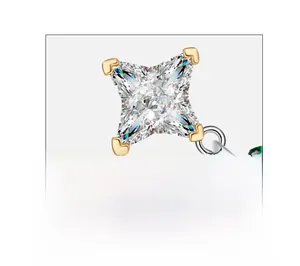 Macro detail of fancy cut high carbon diamond with emerald accent in four-prong gold setting