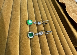 Detail of 925 sterling silver stamp on square emerald drop earrings with clear zircons