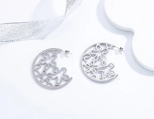 Close-up of S925 sterling silver hollow flower earrings with micro-set zircons