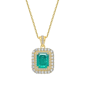 Elegant emerald-cut green gemstone necklace with dual halo diamonds on gold chain