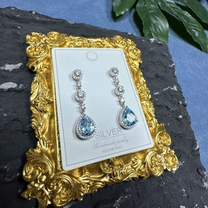 Elegant S925 sterling silver drop earrings with blue pear-cut gemstones and sparkling diamonds