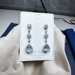 S925 sterling silver drop earrings with light blue pear-cut gemstones and pave diamonds