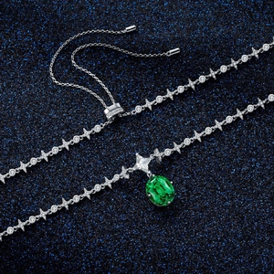 925 silver emerald necklace with star-shaped links and oval green pendant on starry background