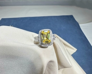 Macro detail of 8x12mm aquamarine ring with halo diamonds and sterling silver band